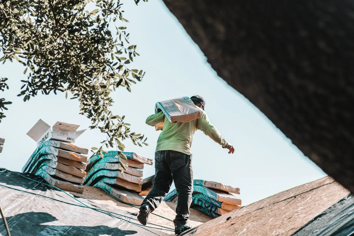Roofers working on a Miami home during a roof replacement